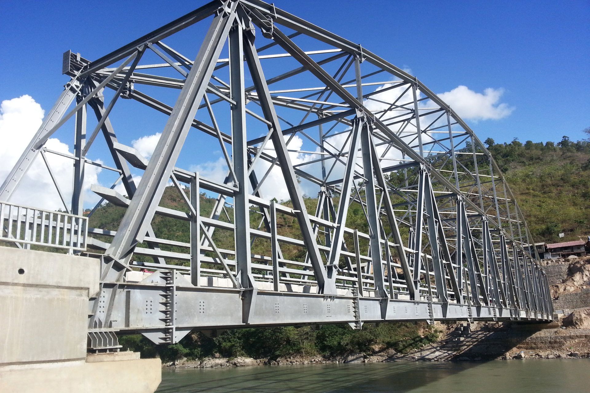 A bridge over a river with a blue sky in the background