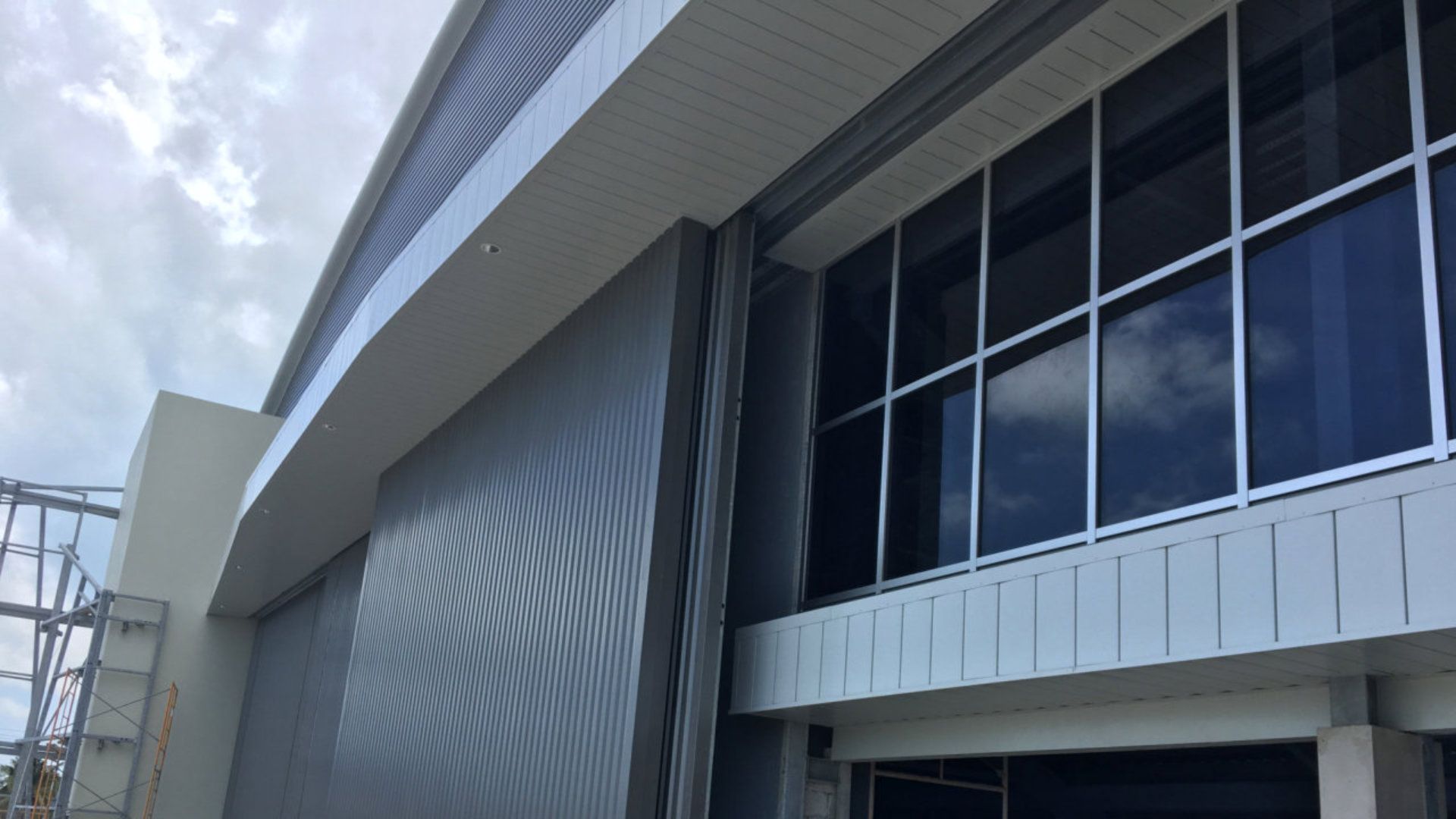 A large building with a lot of windows is under construction.