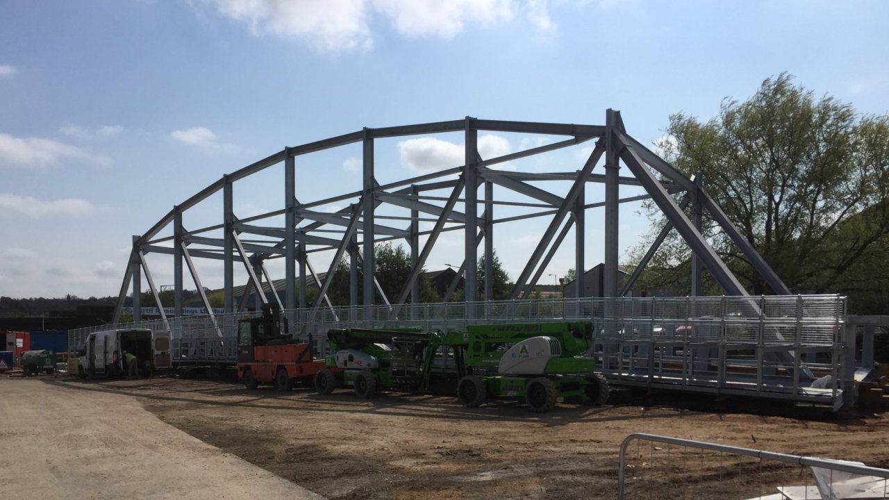 A large bridge structure is being built in adjacent to the river