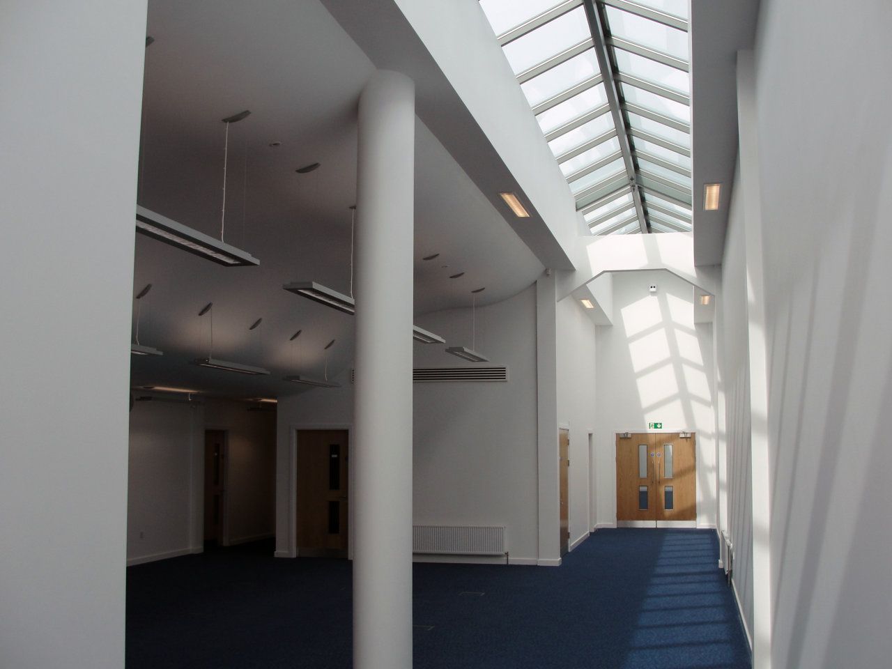 An empty hallway with a skylight in the ceiling