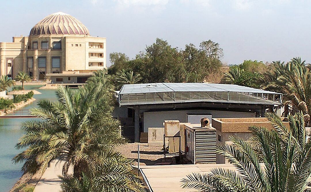 A building with a dome on top of it is surrounded by palm trees