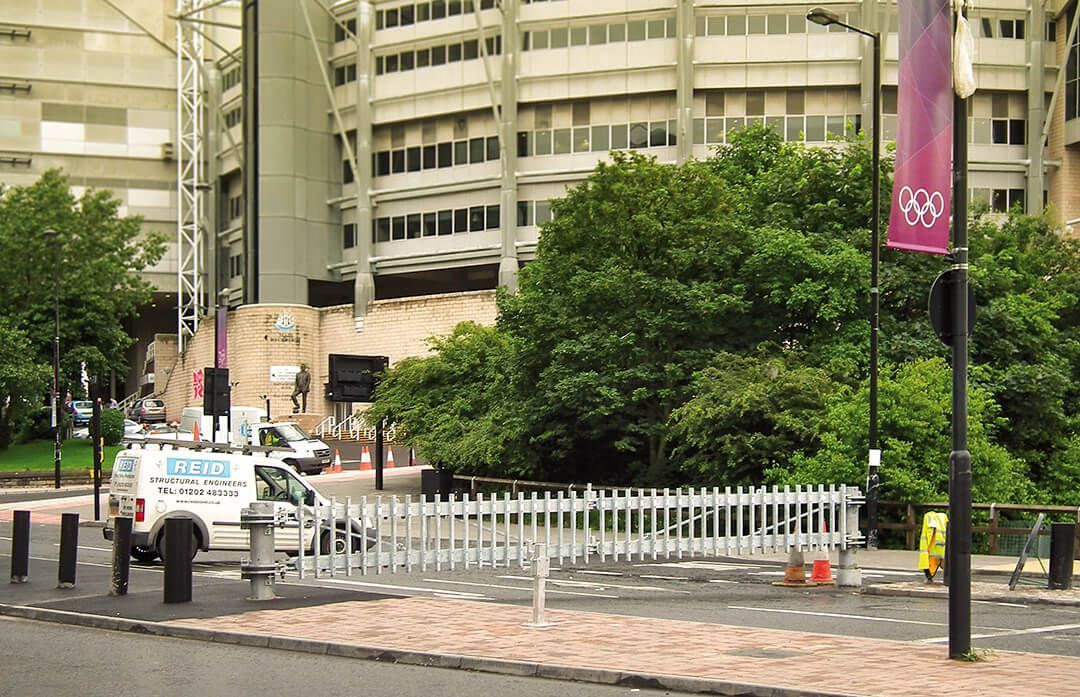 A white truck is parked on the side of the road in front of a building