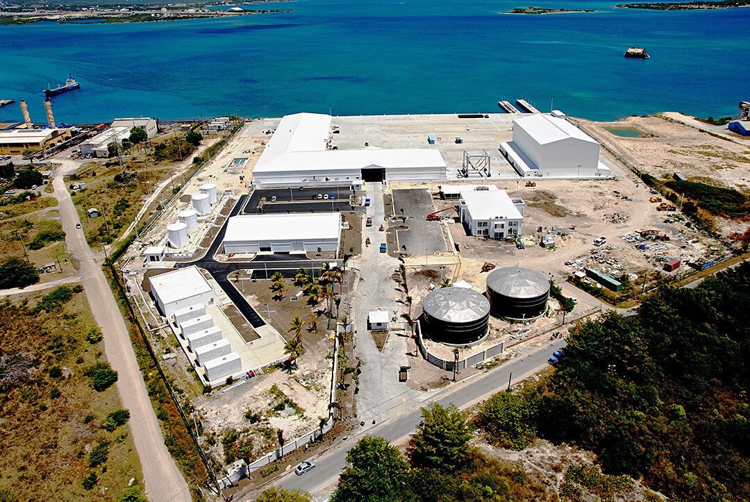 An aerial view of a large building next to a body of water.