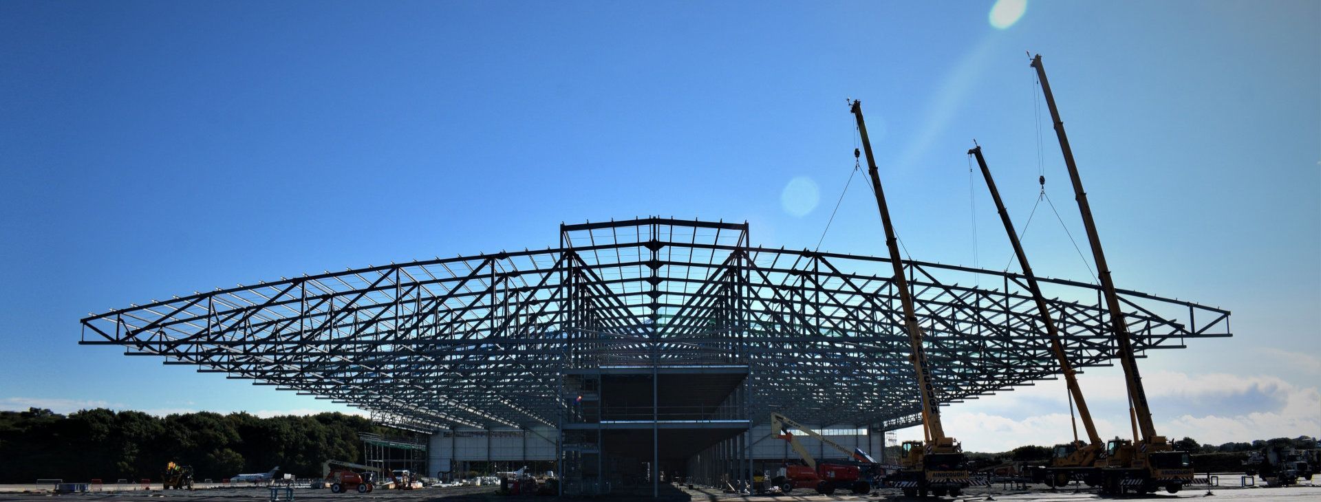 A building under construction with a blue sky in the background