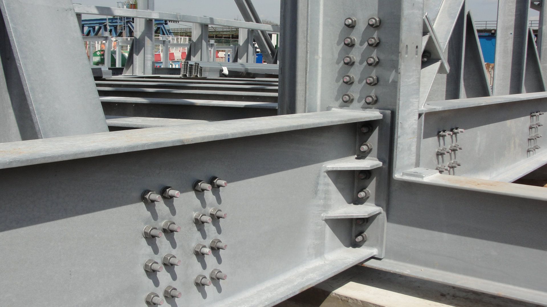 A close up of a metal structure with screws on it