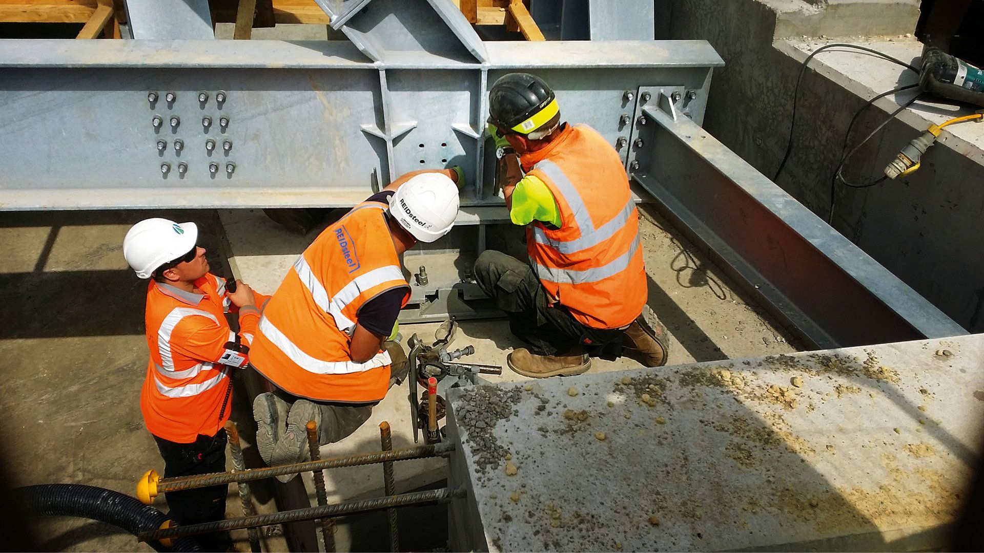 A group of construction workers are working on a bridge.