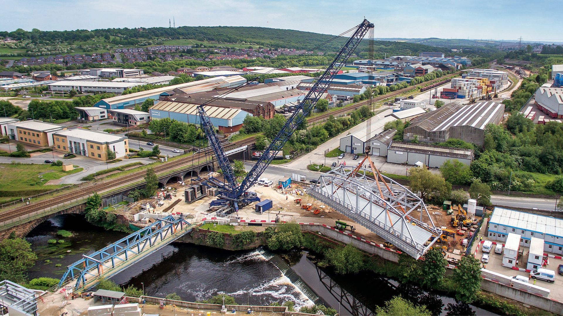 An aerial view of a bridge being built over a river.