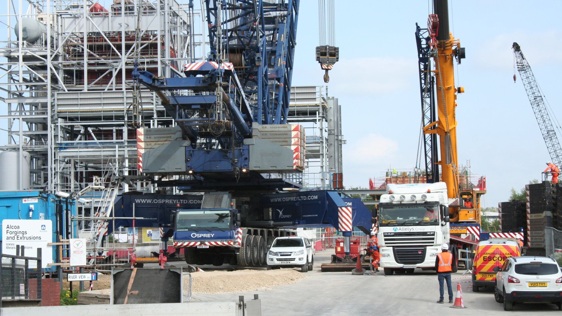 A construction site with a large crane and trucks