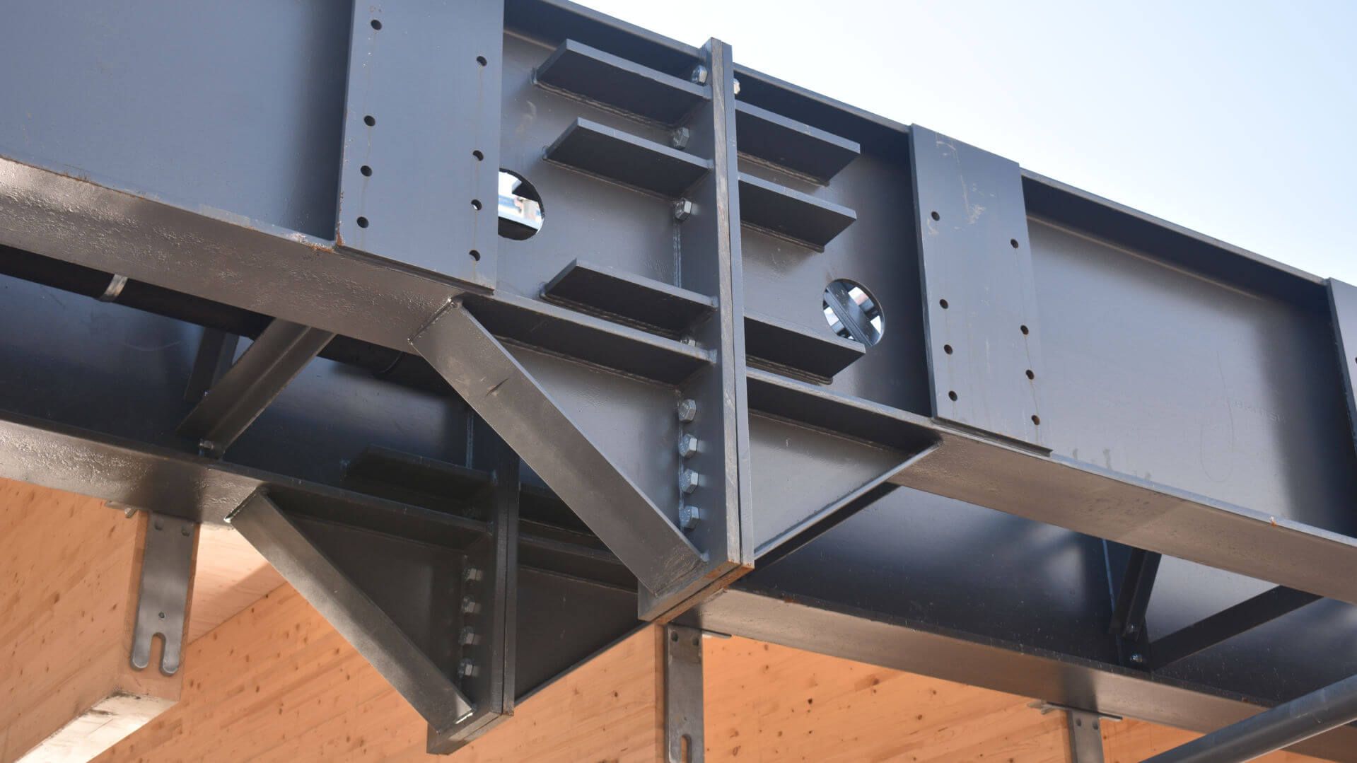 A close up of a metal structure with a blue sky in the background