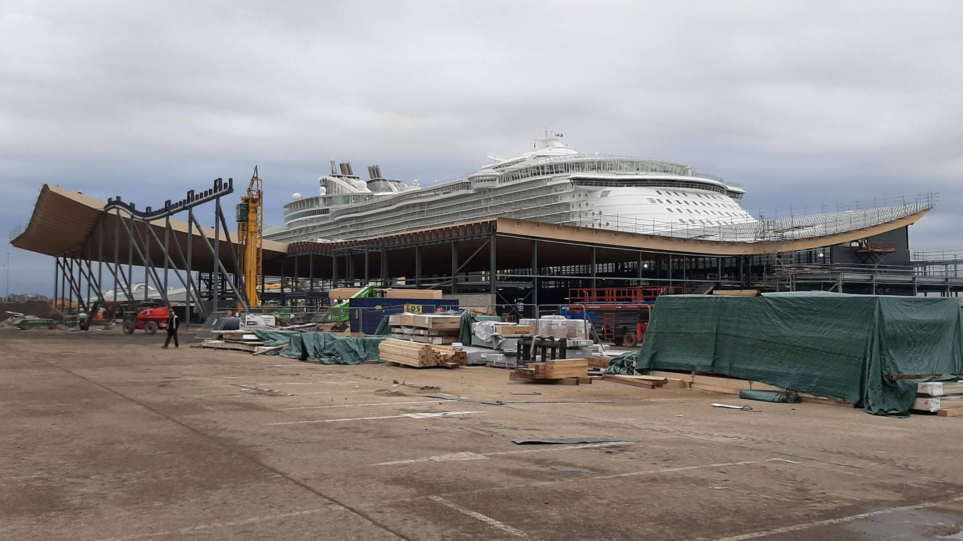 A large cruise ship is being built in a dock.