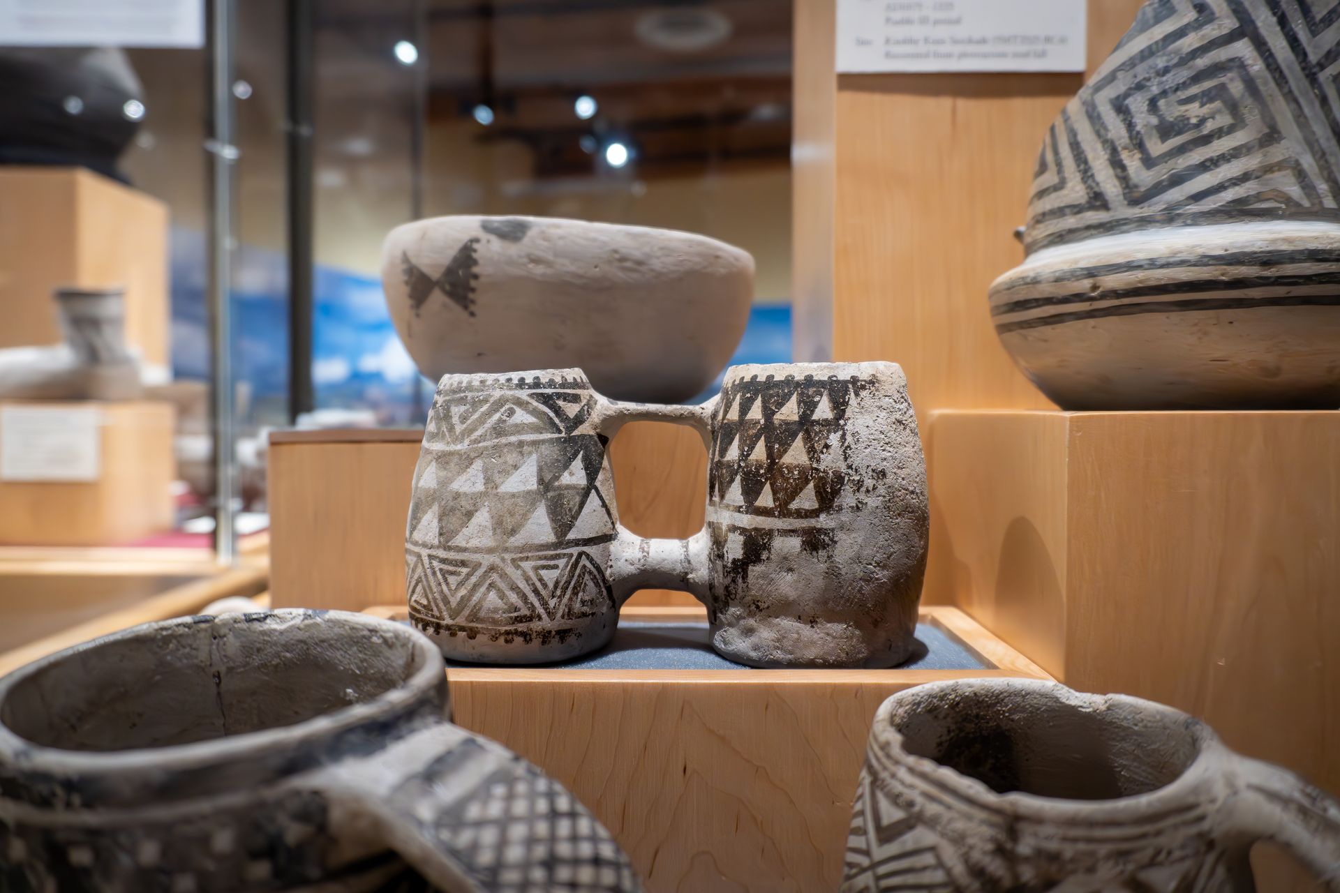There are many different types of pottery on display in a museum.