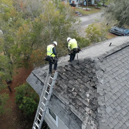 Reliable Lehigh Acres roofers installing new solar shingles, solar roof systems, and photovoltaic energy panels integrated into rooftops.