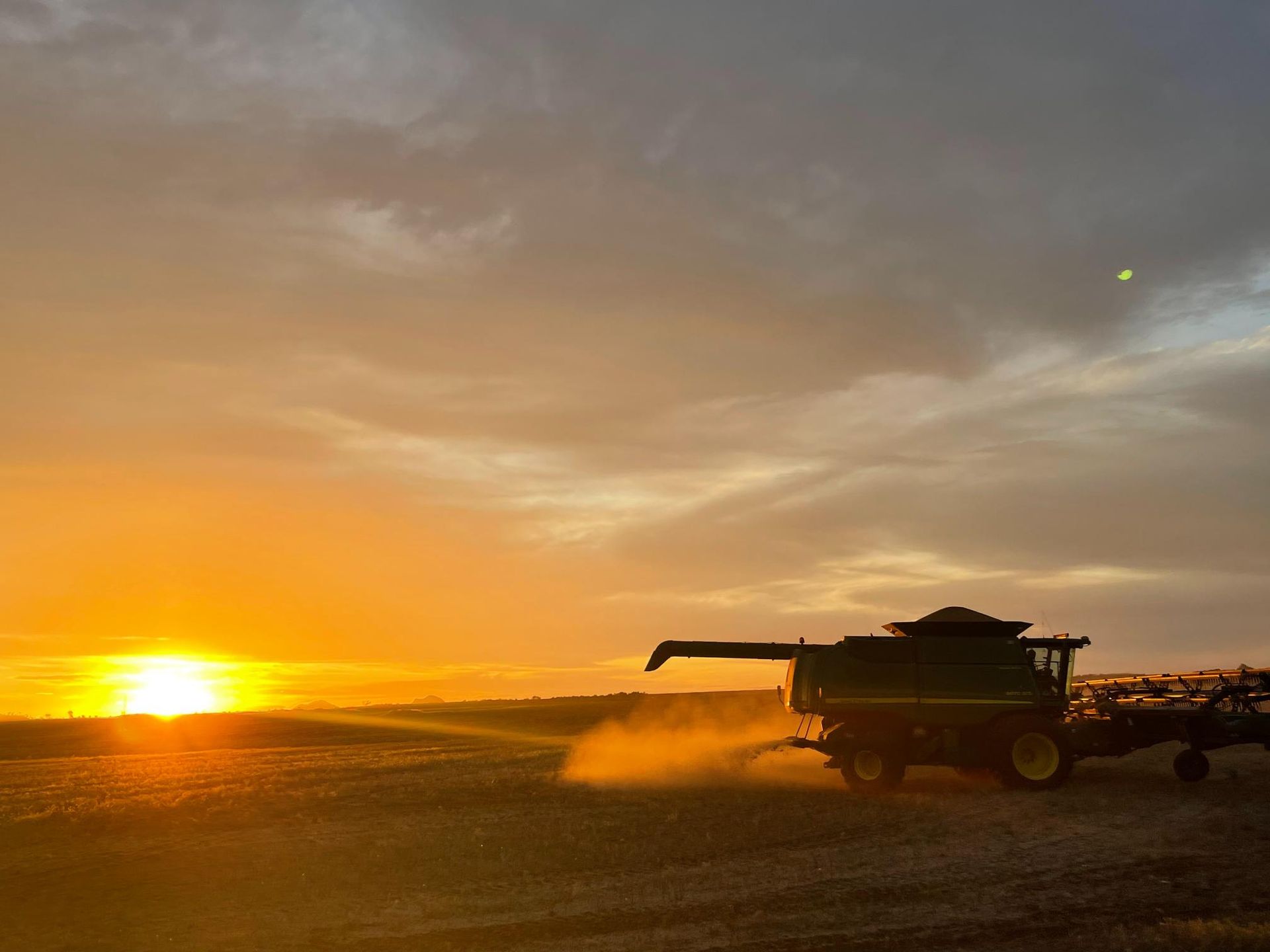 Combine Harvester is Working in a Field at Sunset — MFM Soil Solutions in Ball Bay, QLD