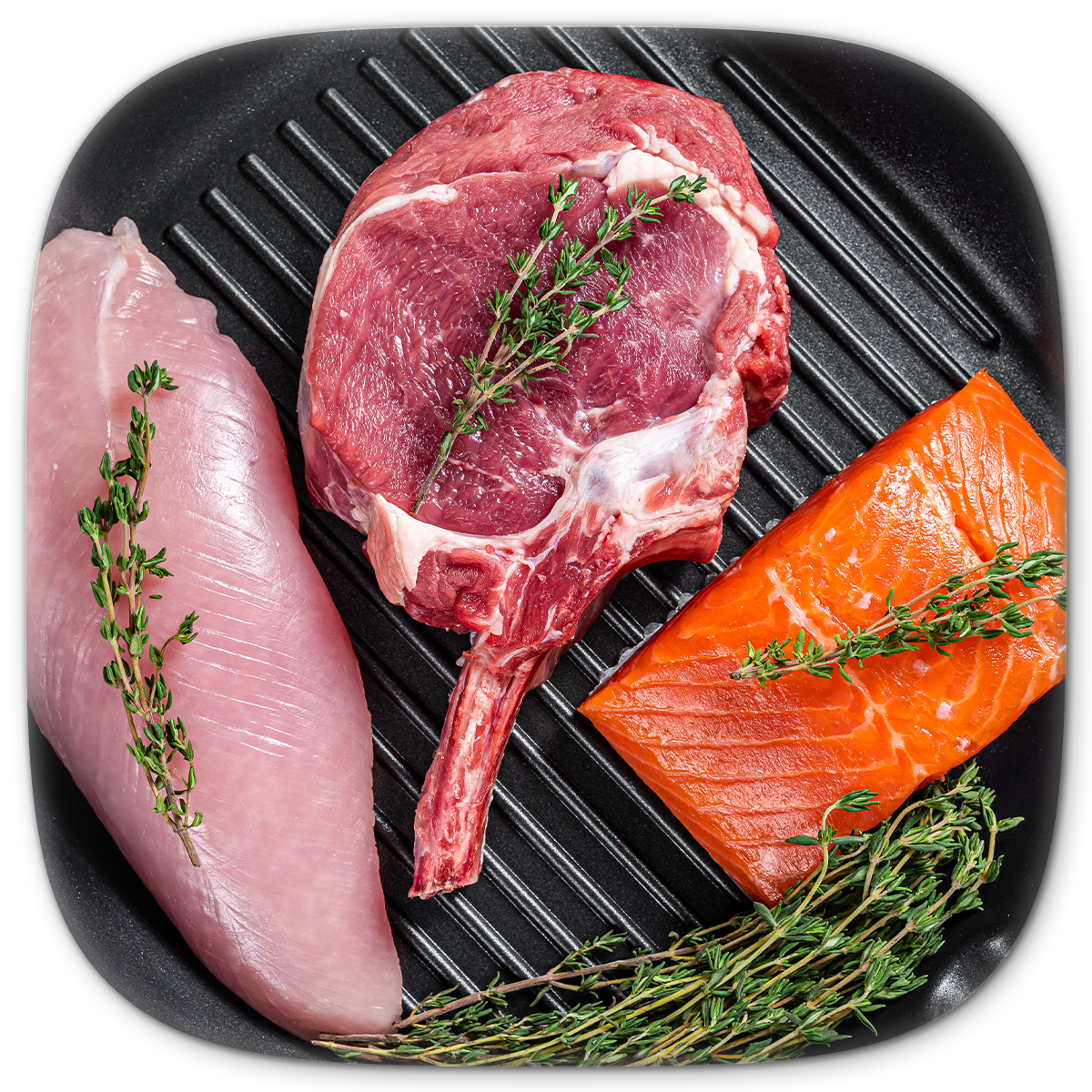 Raw meat and fish (chicken breast, lamb chop, salmon) on a grill pan, garnished with herbs.