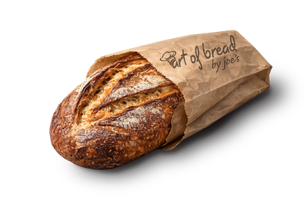 Loaf of artisanal bread in a brown paper bag, labeled