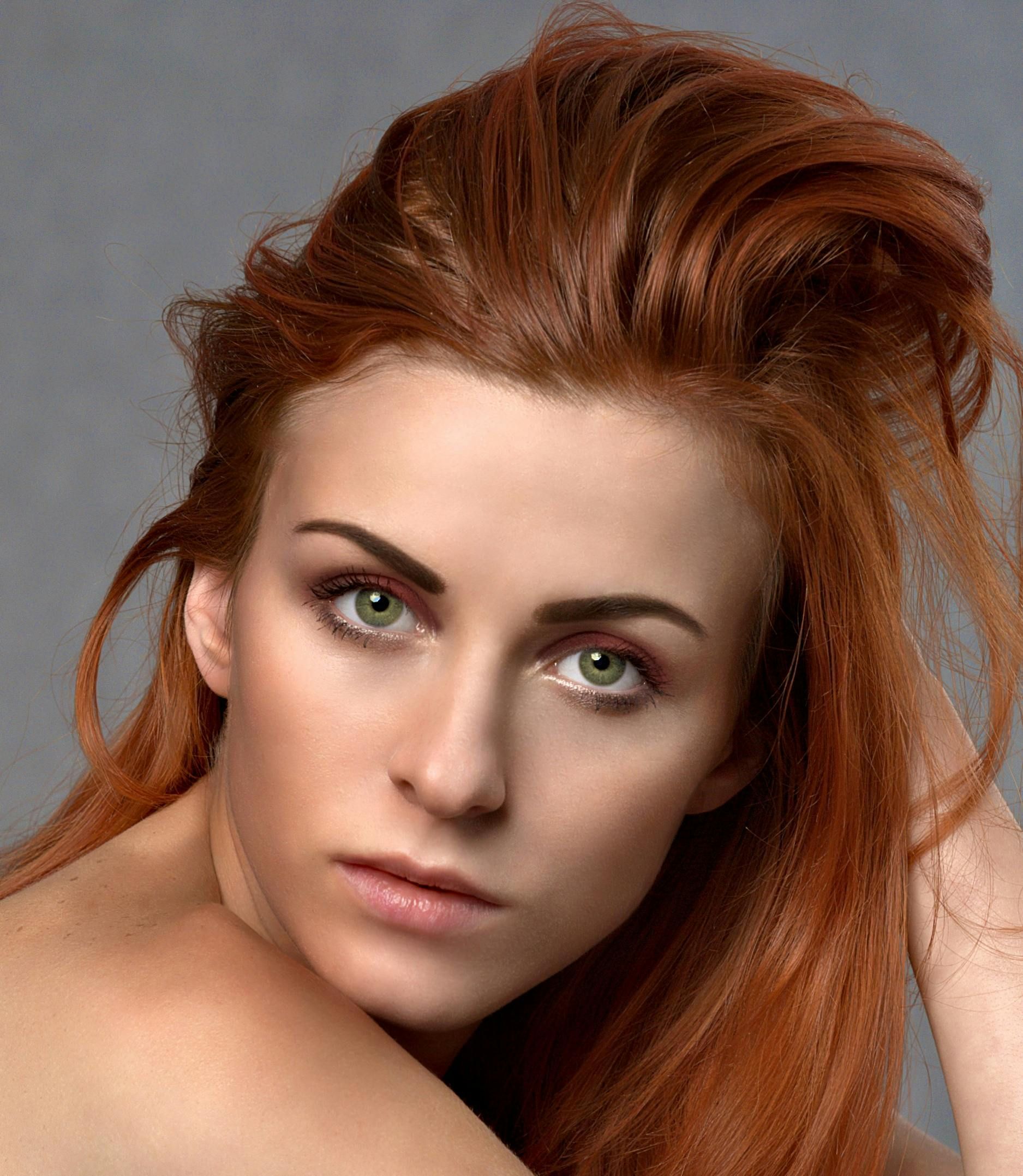 Woman with red hair, green eyes, looking at the viewer.