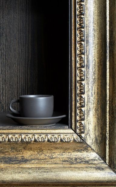 Art framing displayed in Wollongong holding a cup