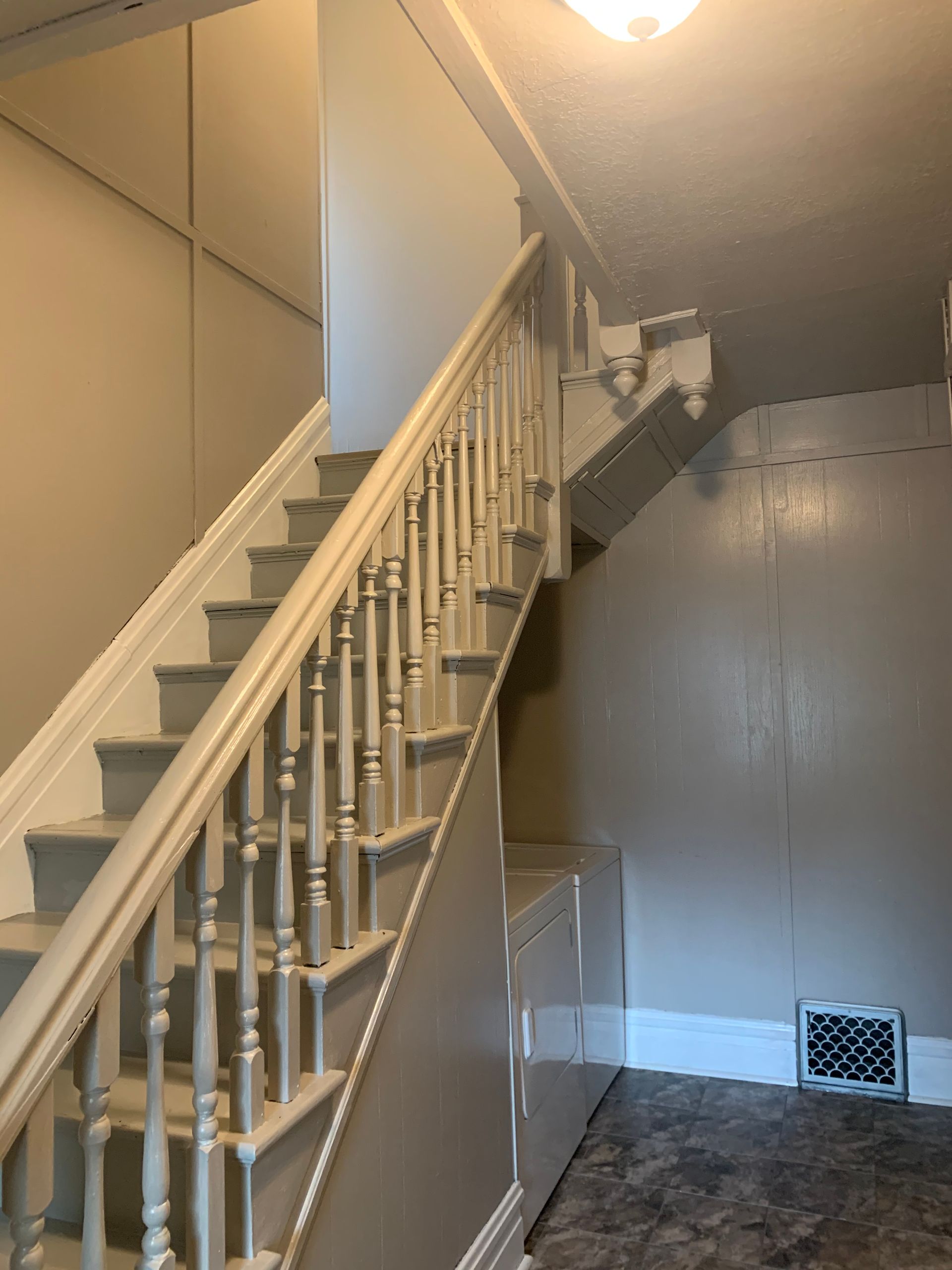 A staircase in a house with a white railing