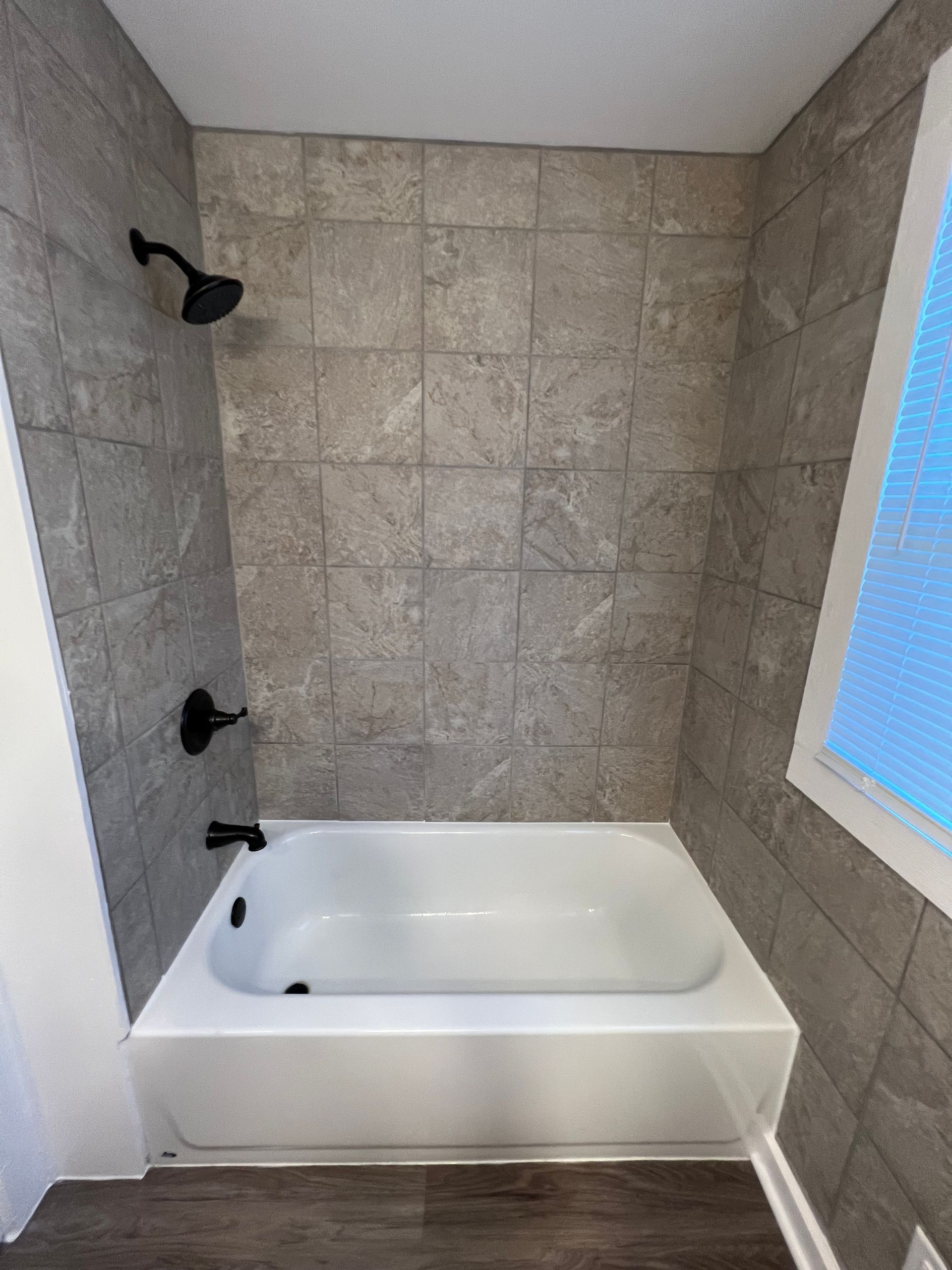 A bathroom with a bathtub and a shower.