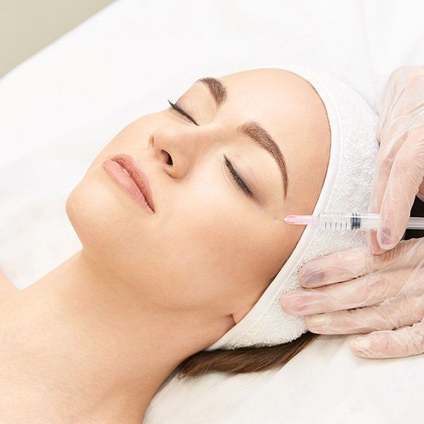 Woman Getting an Injection — Metairie, LA — Dr. Carter D. Paddock