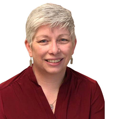 A woman wearing a red shirt and earrings is smiling for the camera.
