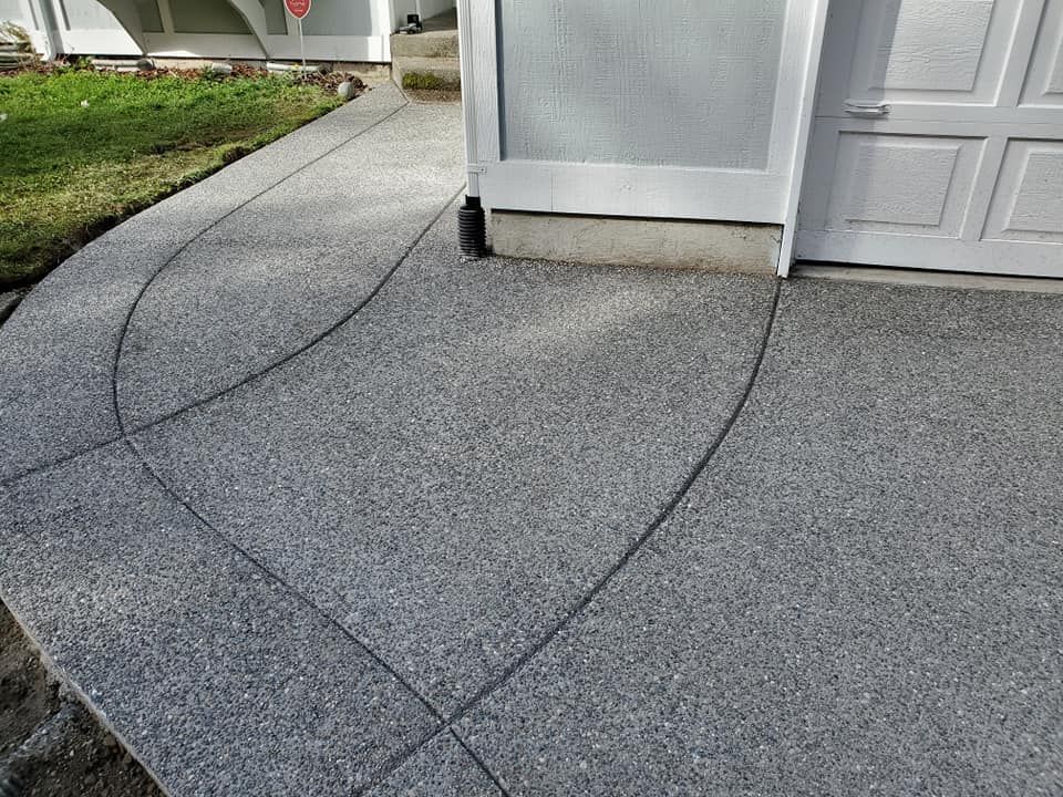 Exposed aggregate entryway designed to complement landscaping and exterior siding