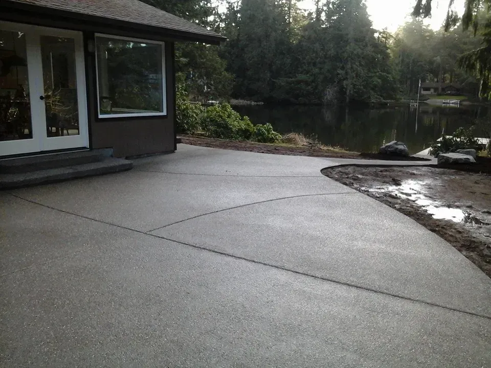 Decorative backyard concrete slab overlooking waterfront