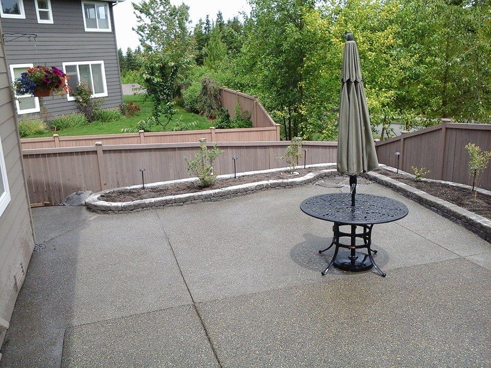 Residential outdoor living space with smooth concrete edges and integrated garden
