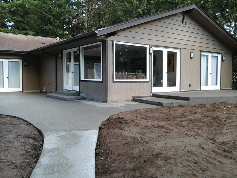 Residential concrete patio installation with smooth broom finish