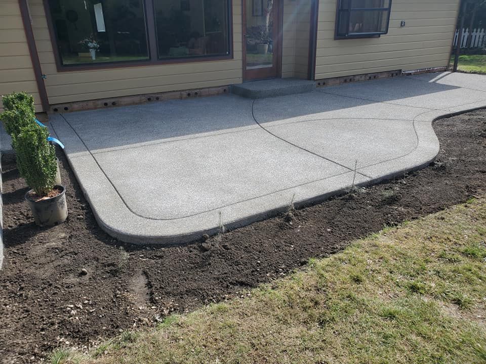 Curved backyard patio slab with visible control joints