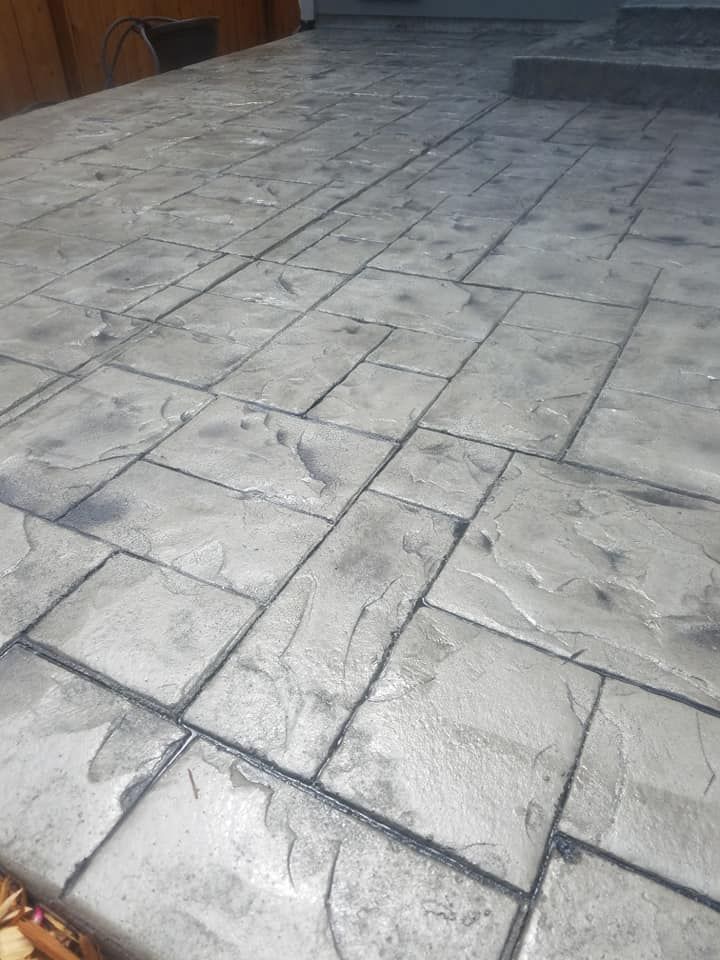Custom stamped concrete patio surface with multi-tone gray finish