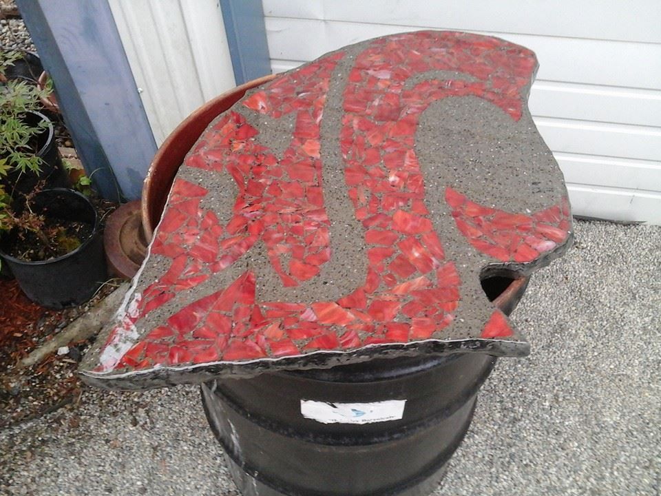 Custom mosaic concrete countertop with red glass inlay design