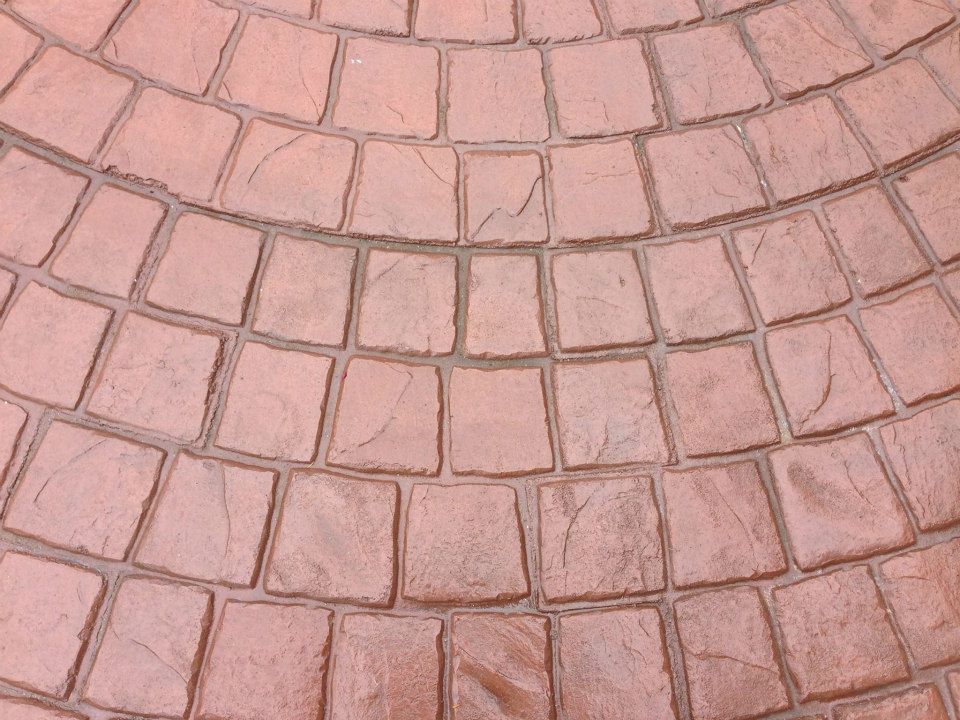 Decorative stamped concrete patio with curved layout design