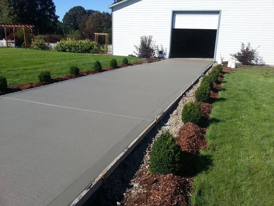 Long straight concrete airplane approach leading to detached garage with smooth finish