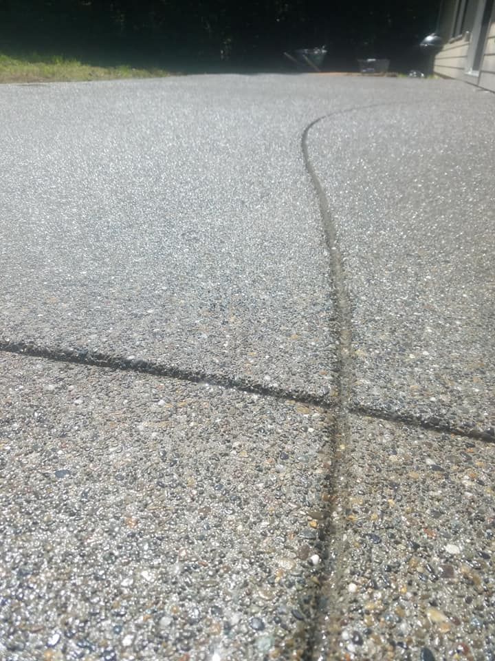 Exposed stone concrete slab with smooth sealed appearance