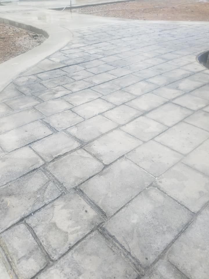 Stained stamped concrete flatwork with realistic stone appearance