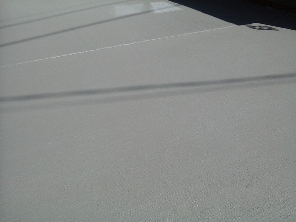 Smooth finished concrete slab with fine broom texture