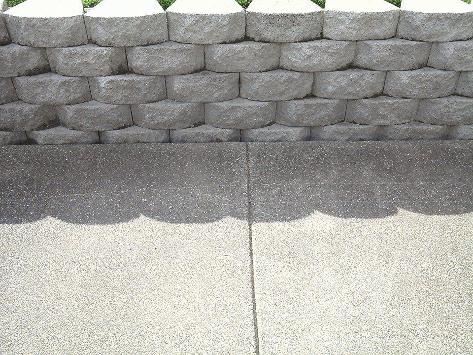 Custom backyard patio installation with textured pebble finish