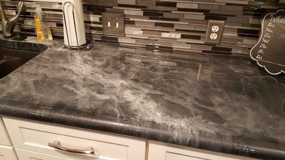 Close up of metallic concrete countertop showing high gloss marbled finish and smooth rounded edge