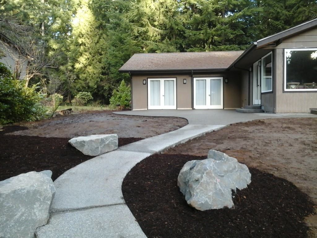 Residential concrete patio installation with smooth broom finish