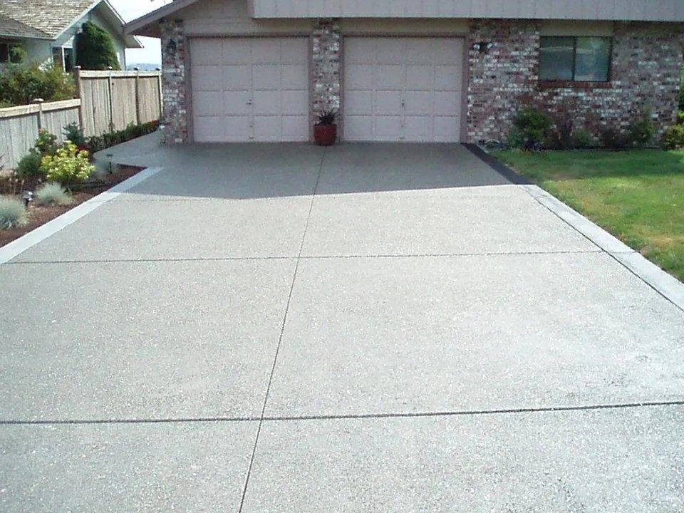 Residential exposed aggregate driveway installation with crisp edge detail