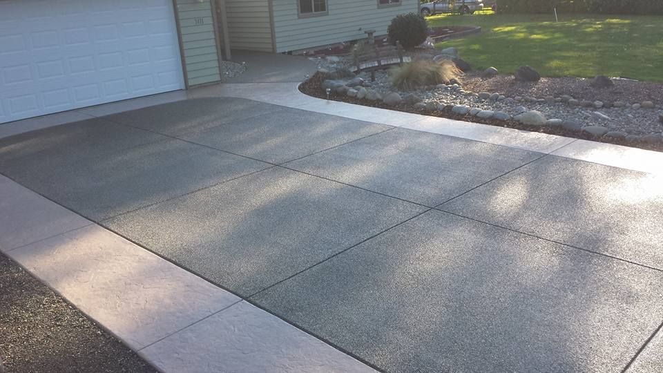 Exposed aggregate concrete driveway with smooth perimeter border