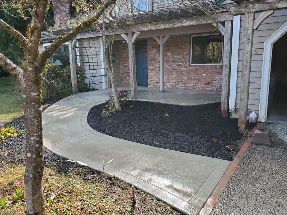 Curved concrete walkway leading to covered front porch entry