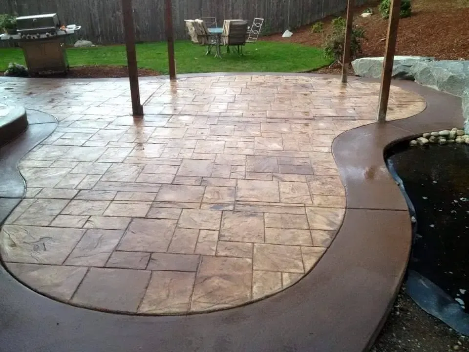 Curved patio with colored concrete border detail
