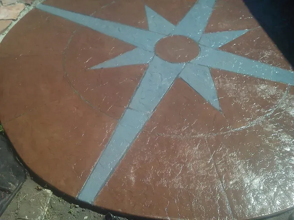 Residential patio installation with compass themed detail