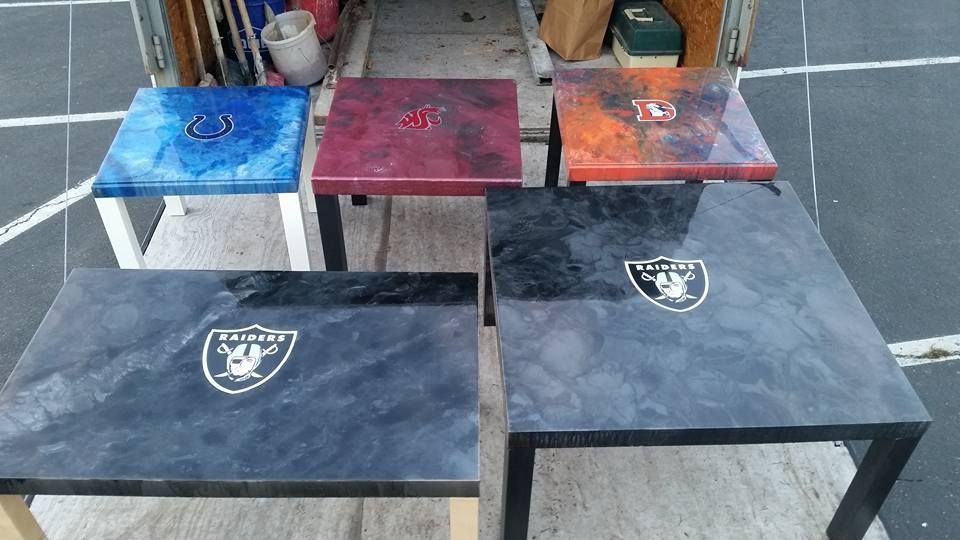 Custom concrete tables featuring embedded sports team logos