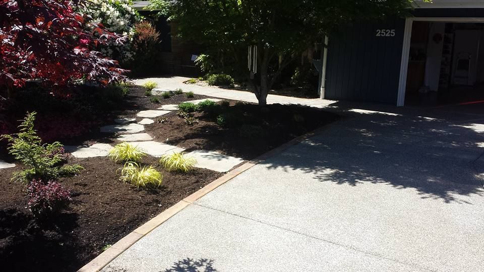 Exposed aggregate concrete driveway with curved border edging
