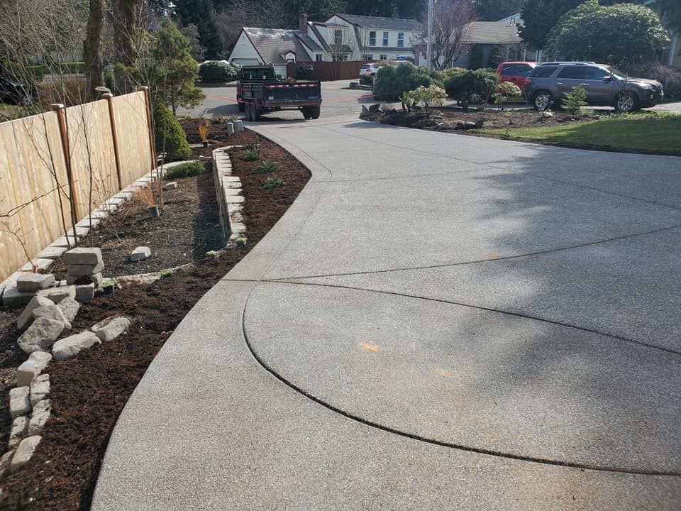 Custom aggregate flatwork with landscaped edge border