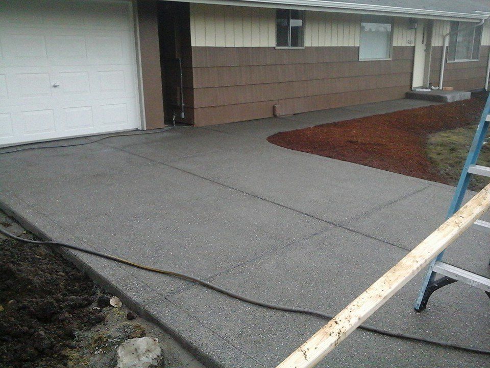 Professional concrete driveway installation with broomed control lines