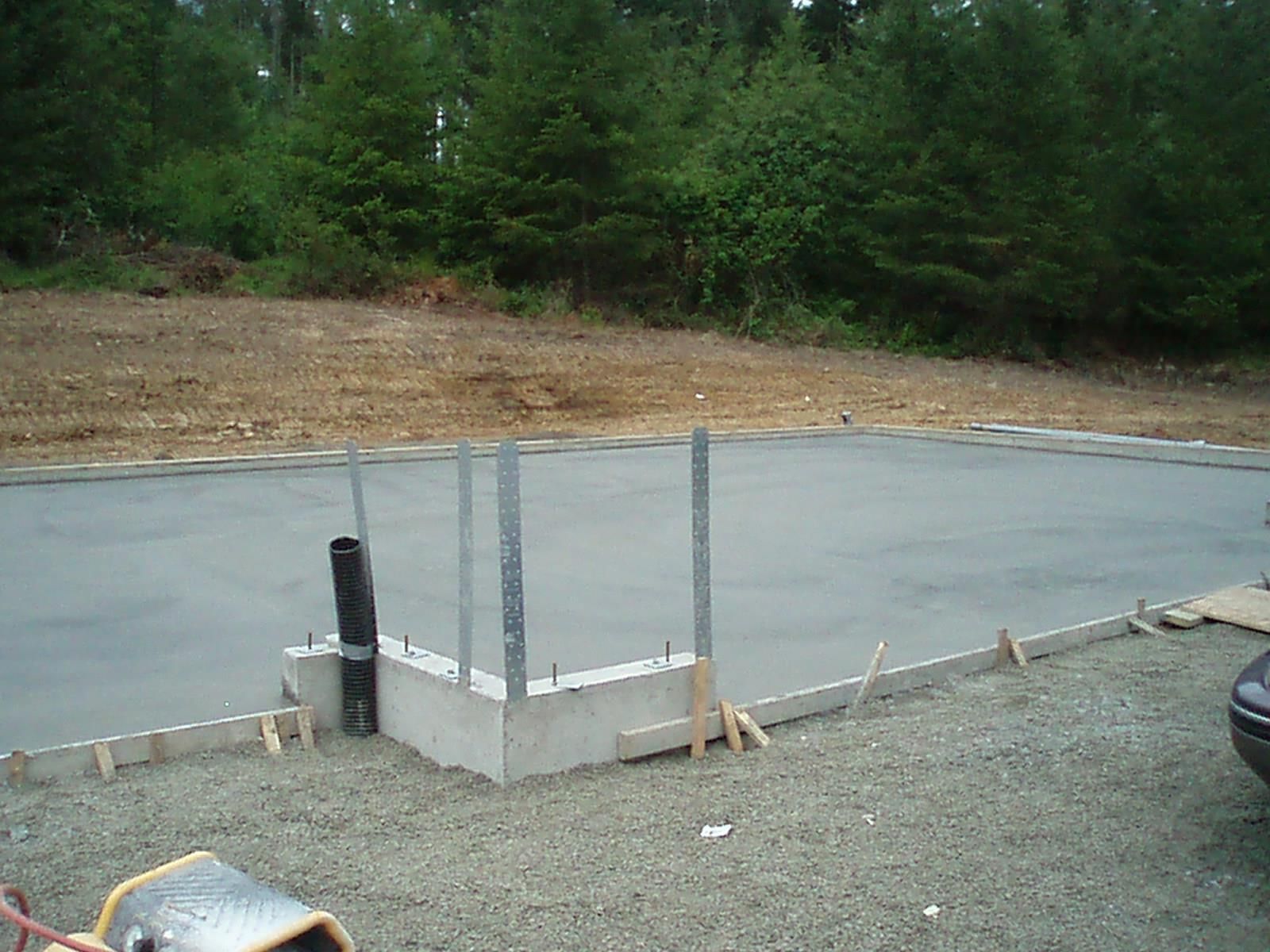 Concrete slab foundation with perimeter footing and anchor bolts